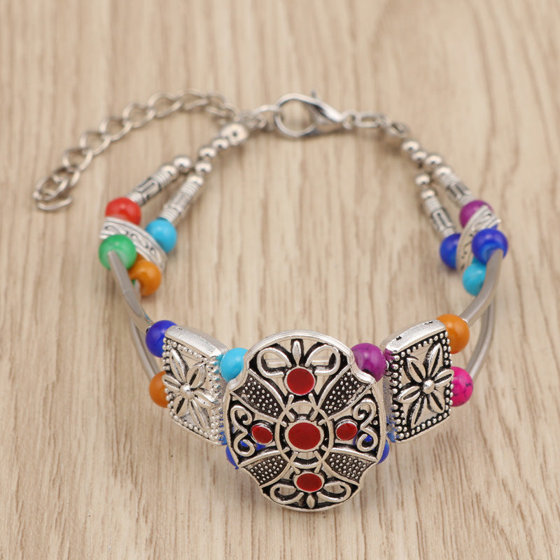 Pulsera de metal con cuentas florales coloridas